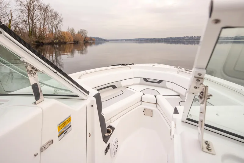Slide: The Image of 2024 Blackfin 232DC Dual Console boat interior with scenic lake view. - 21
