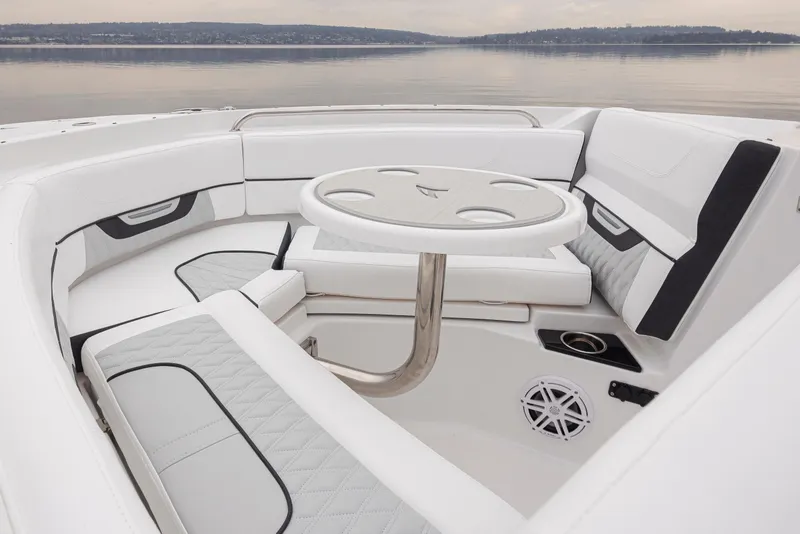 Slide: The Image of 2024 Blackfin 232DC Dual Console boat interior with white seating and round table. - 26