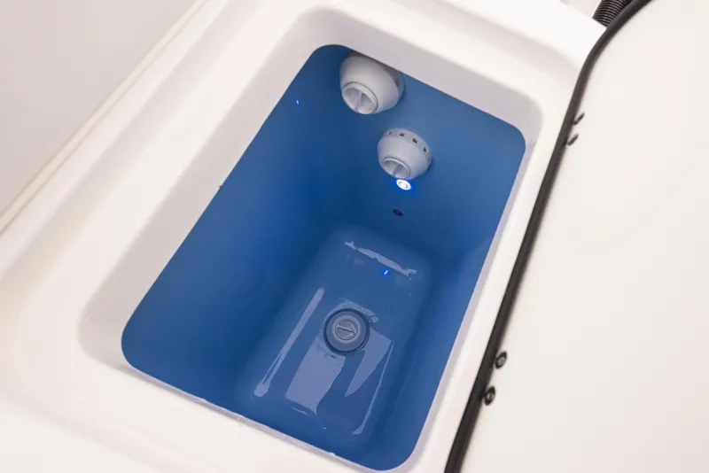 Slide: The Image of 2024 Blackfin 232DC Dual Console livewell with blue interior and water circulation system. - 27