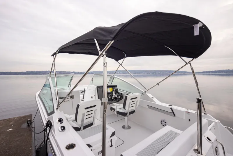 Slide: The Image of 2024 Blackfin 232DC Dual Console boat with canopy on calm water. - 30
