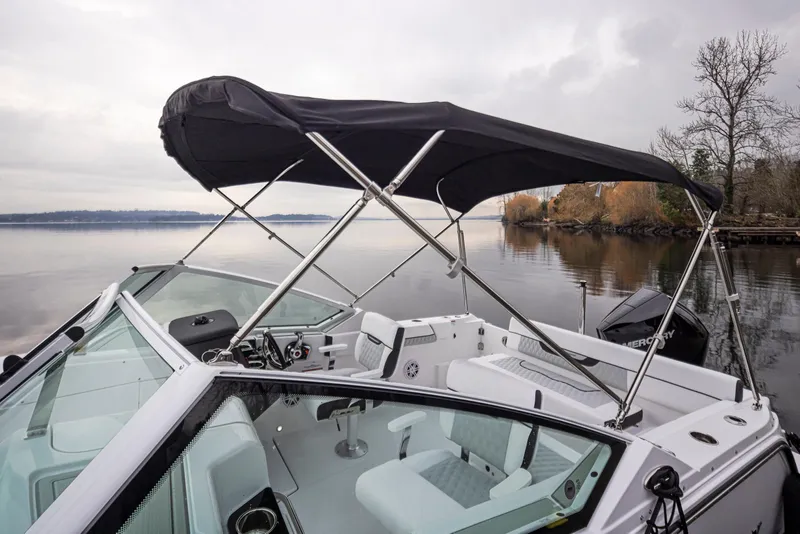 Slide: The Image of 2024 Blackfin 232DC Dual Console boat with canopy on a calm lake. - 32