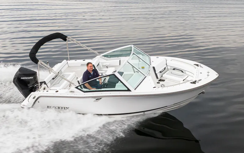 Slide: The Image of 2024 Blackfin 232DC Dual Console boat cruising on calm water. - 39