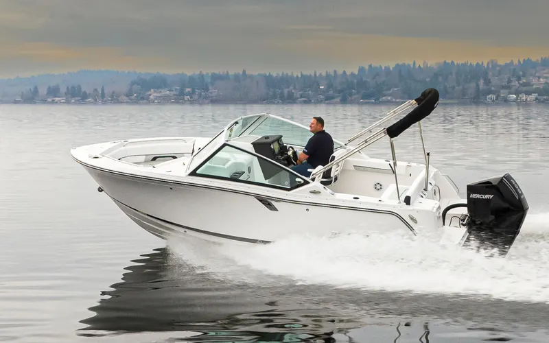Slide: The Image of 2024 Blackfin 232DC Dual Console boat cruising on a calm lake. - 4