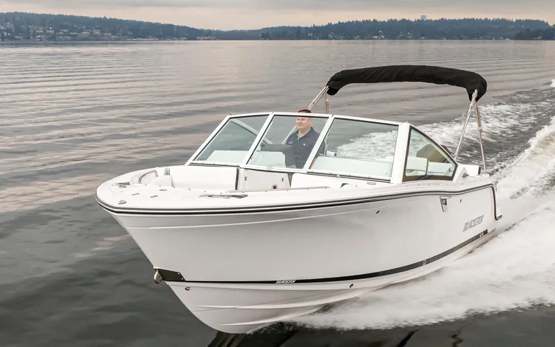 Slide: The Image of 2024 Blackfin 232DC Dual Console boat cruising on calm waters. - 6