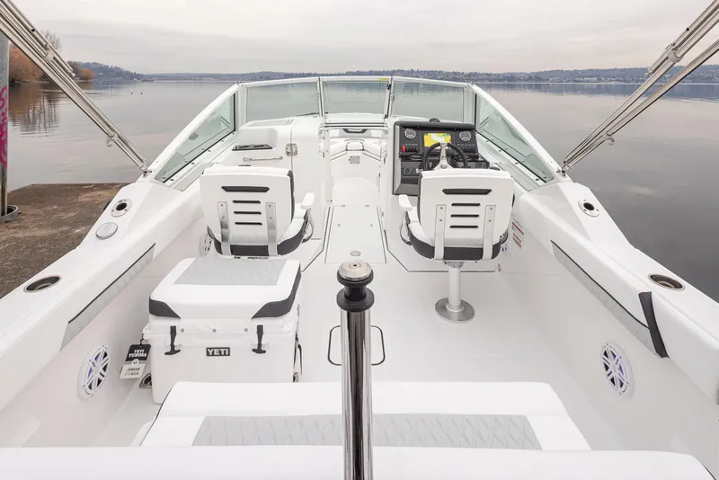 Slide: The Image of 2024 Blackfin 232DC Dual Console boat interior with seating and helm, on calm water. - 9