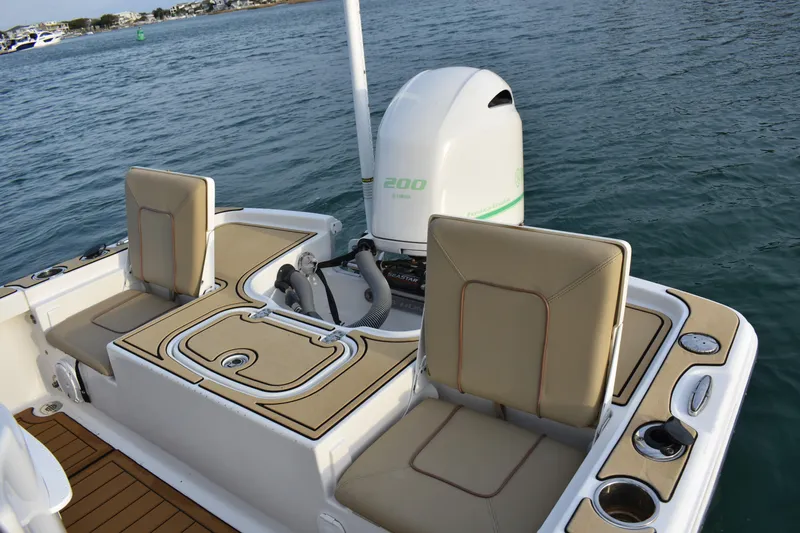 Slide: The Image of 2018 Sea Hunt BX 22 BR boat interior with seating and outboard motor on water. - 13