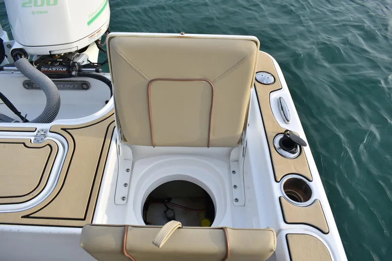 Slide: The Image of 2018 Sea Hunt BX 22 BR boat interior with seating and engine details. - 14