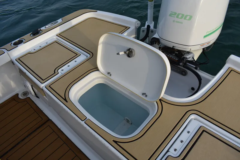 Slide: The Image of 2018 Sea Hunt BX 22 BR boat with open storage compartment and Yamaha 200 engine. - 16