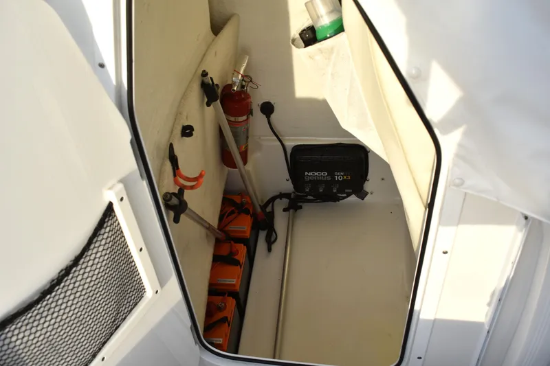 Slide: The Image of Storage compartment of a 2018 Sea Hunt BX 22 BR boat with safety equipment. - 21