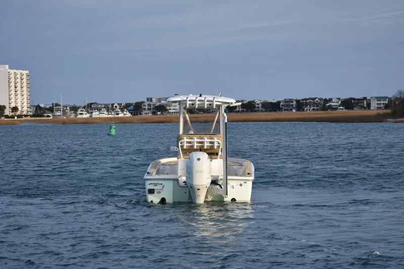 Slide: The Image of 2018 Sea Hunt BX 22 BR boat on water near coastal buildings. - 4
