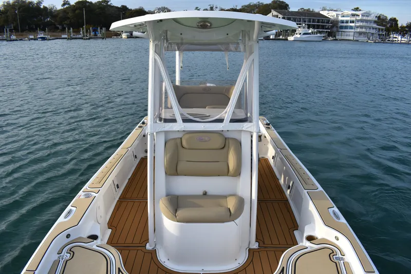 Slide: The Image of 2018 Sea Hunt BX 22 BR boat on water, featuring spacious deck and seating. - 9