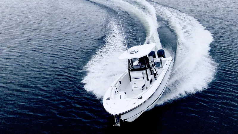 Slide: The Image of 2023 Blackfin 252 CC boat cruising on open water, creating a dynamic wake. - 2