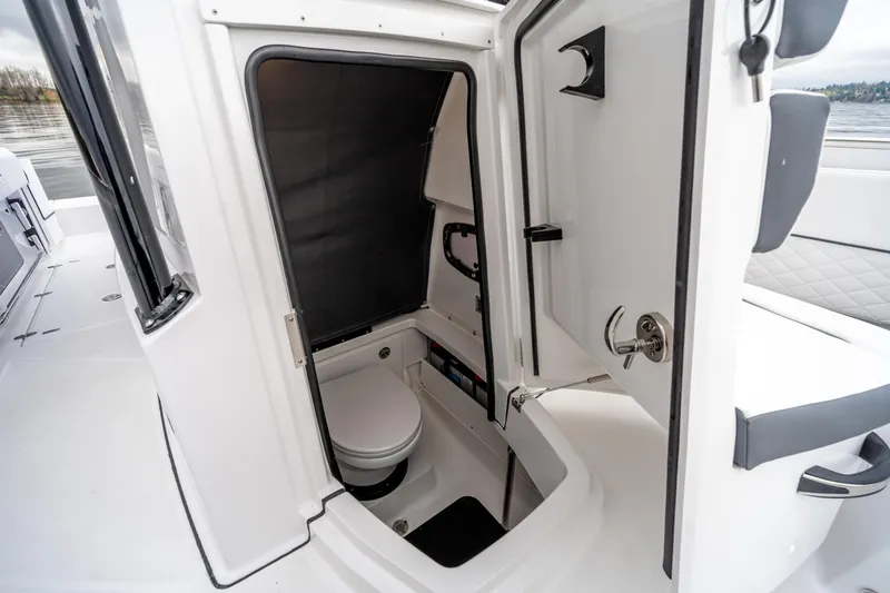 Slide: The Image of 2023 Blackfin 252 CC boat interior with compact marine toilet. - 20