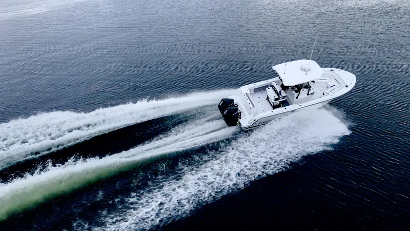 Slide: The Image of 2023 Blackfin 252 CC boat cruising on open water, aerial view. - 26