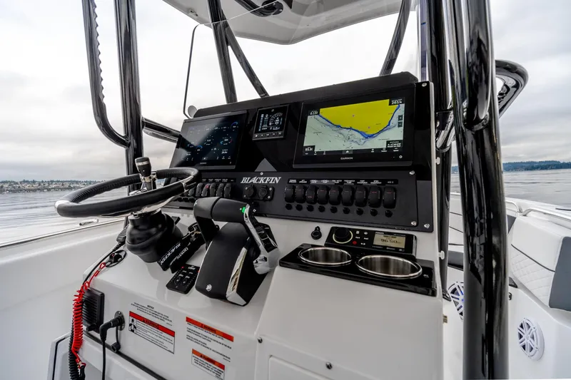 Slide: The Image of 2023 Blackfin 252 CC boat dashboard with navigation screens and controls. - 5