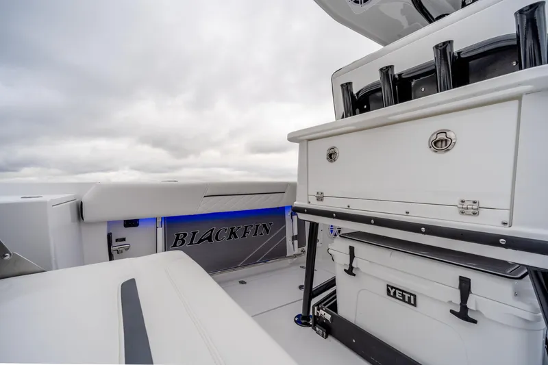 Slide: The Image of 2023 Blackfin 252 CC boat interior with Yeti cooler and storage compartments. - 8