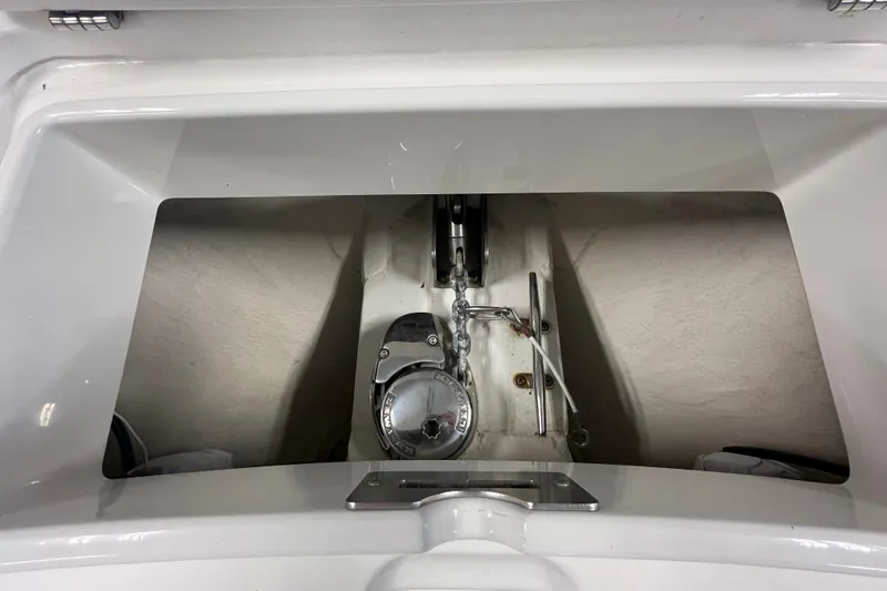 Slide: The Image of 2015 Regulator 25 boat anchor compartment with chain and winch. - 25