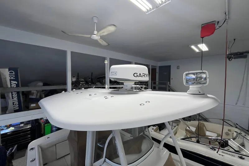Slide: The Image of 2015 Regulator 25 boat with Garmin radar and spotlight in a garage. - 27
