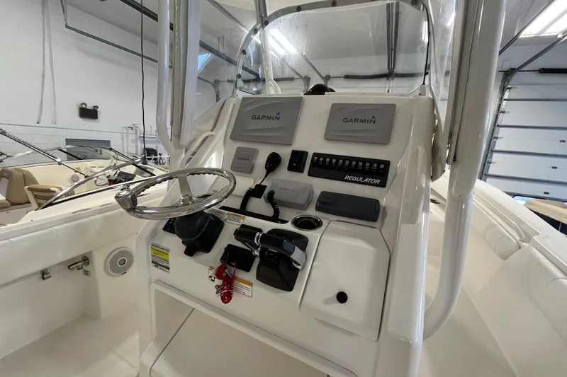 Slide: The Image of 2015 Regulator 25 boat console with Garmin navigation system in a garage setting. - 28