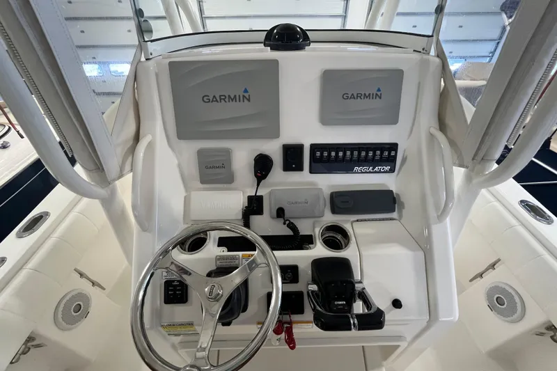 Slide: The Image of 2015 Regulator 25 boat console with Garmin navigation and Yamaha controls. - 33