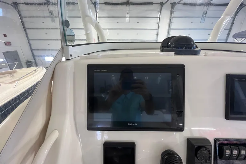 Slide: The Image of Control panel of a 2015 Regulator 25 boat with Garmin GPS display. - 36