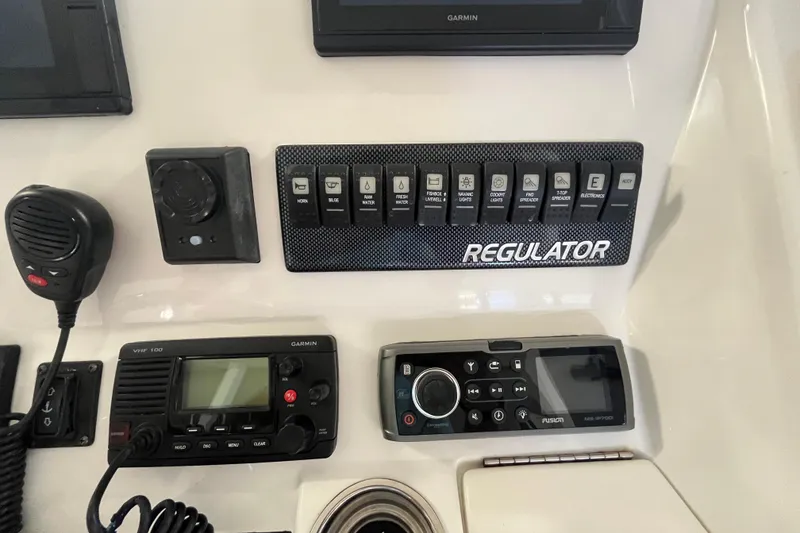 Slide: The Image of Control panel of a 2015 Regulator 25 boat with Garmin and Fusion electronics. - 38