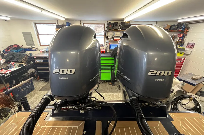 Slide: The Image of Twin Yamaha 200 outboard engines on a 2015 Regulator 25 boat in a workshop. - 40