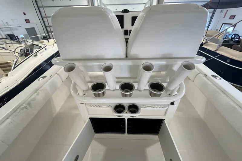 Slide: The Image of 2015 Regulator 25 boat interior with rod holders and storage compartments. - 43