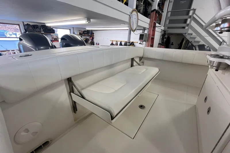 Slide: The Image of 2015 Regulator 25 boat interior with foldable white bench seat. - 44