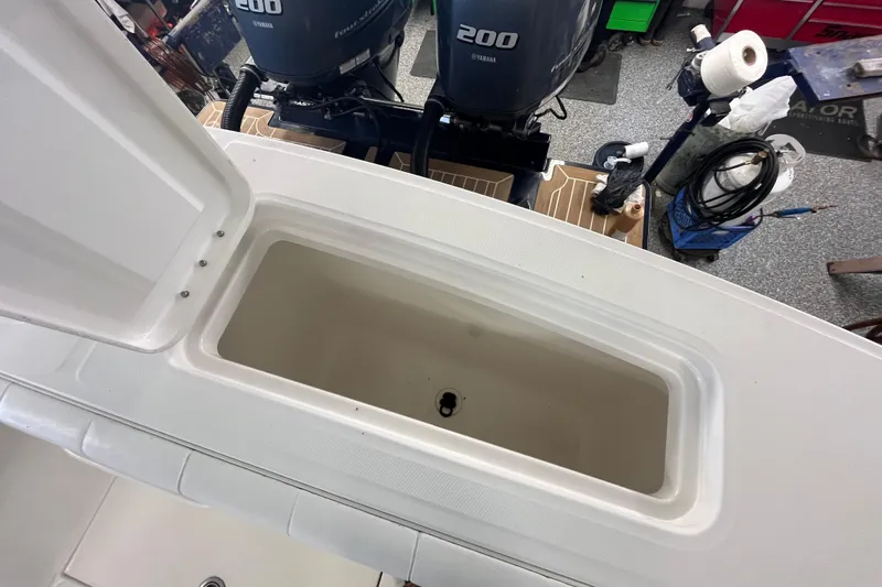 Slide: The Image of 2015 Regulator 25 boat with open storage compartment and twin Yamaha 200 engines. - 46