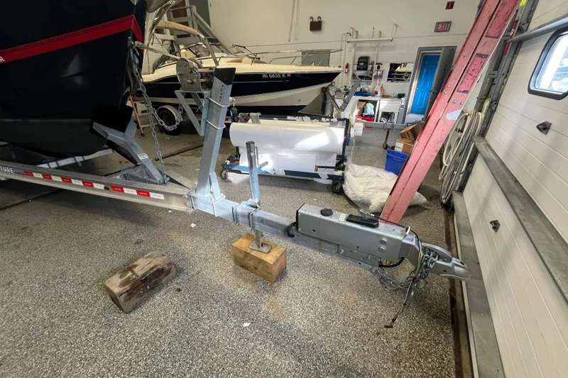 Slide: The Image of Boat trailer in garage with Regulator 25, 2015 model, on blocks. - 59