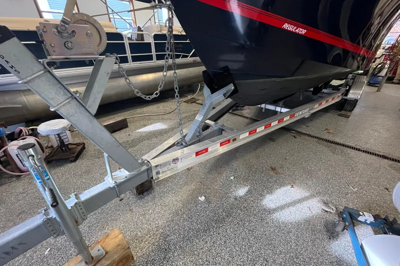 Slide: The Image of 2015 Regulator 25 boat on trailer in garage setting. - 61