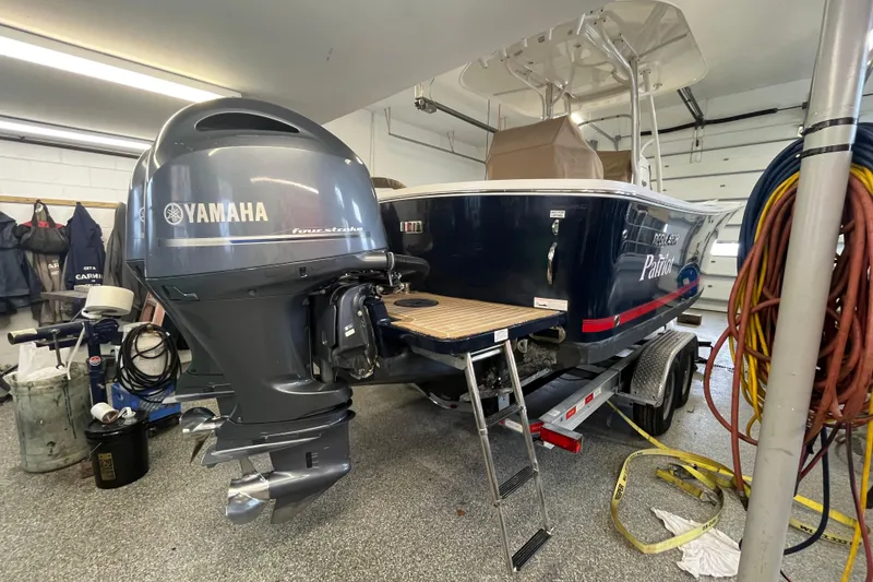 Slide: The Image of 2015 Regulator 25 boat with Yamaha outboard motor in a garage setting. - 8