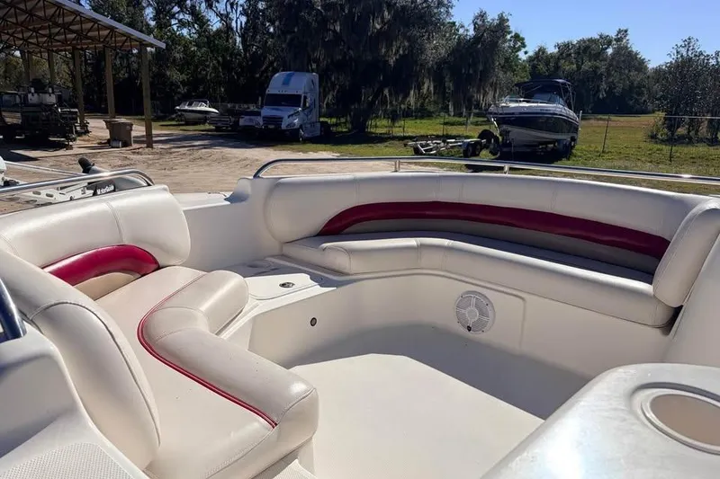 Slide: The Image of 2007 Hurricane FunDeck GS 201 OB boat interior with white and red seating, parked outdoors. - 7