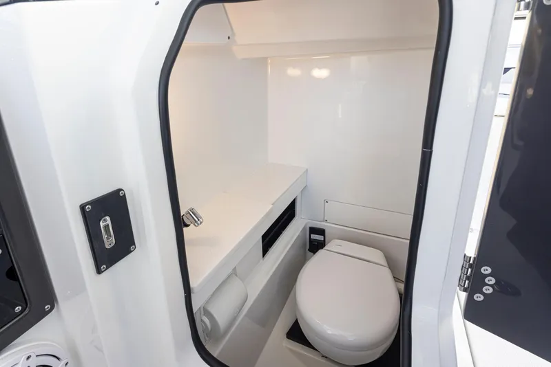 Slide: The Image of 2024 Blackfin 252 DC boat interior with compact bathroom and toilet. - 26