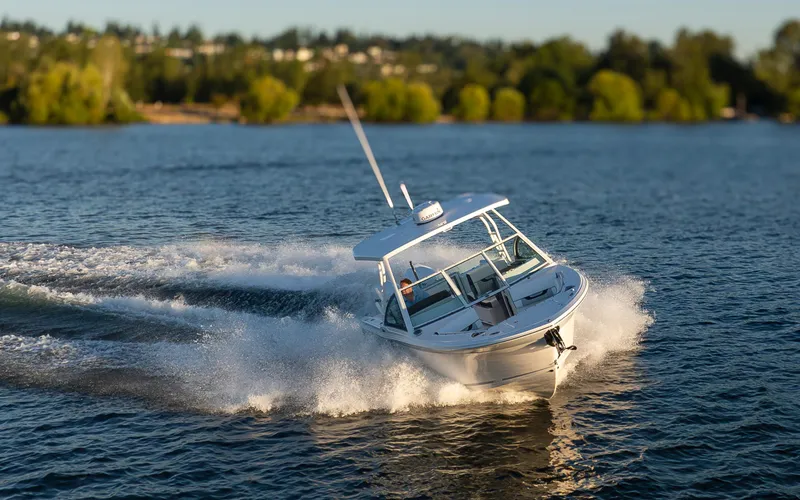 Slide: The Image of 2024 Blackfin 252 DC boat cruising on a scenic lake with lush green trees. - 42