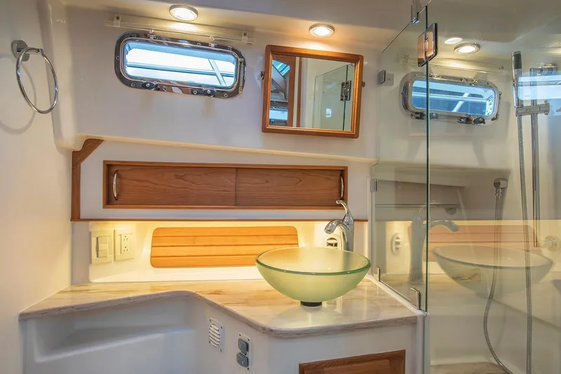 Slide: The Image of Luxurious bathroom in 2026 Sabre 38 Salon Express yacht with glass sink and wooden accents. - 15