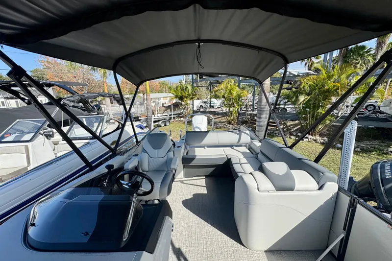 Slide: The Image of 2026 Avalon Catalina Platinum Versatile Rear Bench boat interior with seating and steering console. - 29