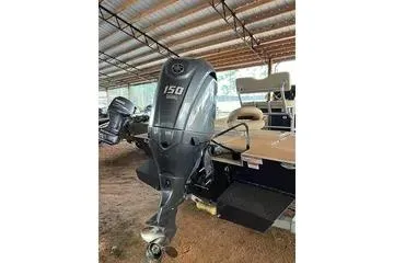 Slide: The Image of 2024 G3 Bay 20 GX boat with 150 HP engine in covered storage. - 11