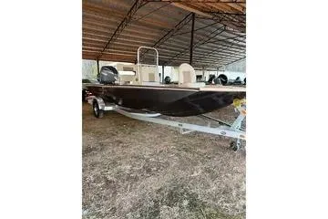 Slide: The Image of 2024 G3 Bay 20 GX boat under shelter on trailer. - 12