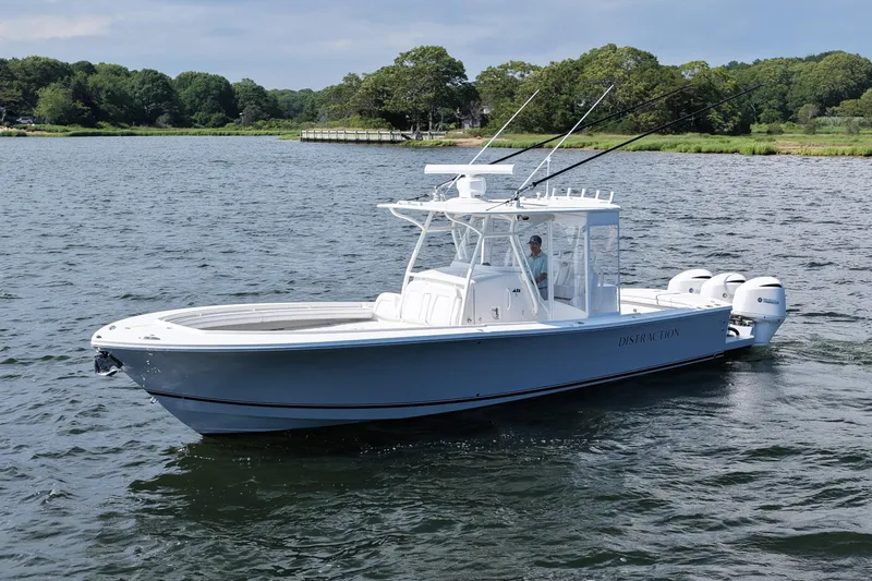 Slide: The Image of 2019 Regulator 34SS boat on water, featuring triple outboard engines and fishing rods. - 10