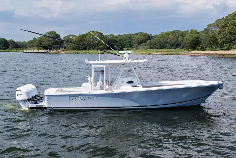 Slide: The Image of 2019 Regulator 34SS boat on water, featuring dual Yamaha engines and sleek design. - 2