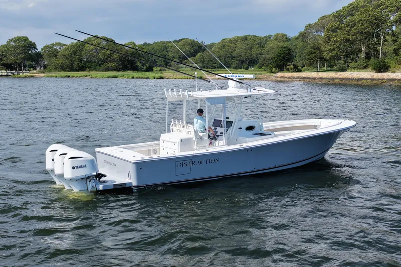 Slide: The Image of 2019 Regulator 34SS boat on water with Yamaha engines, surrounded by greenery. - 3