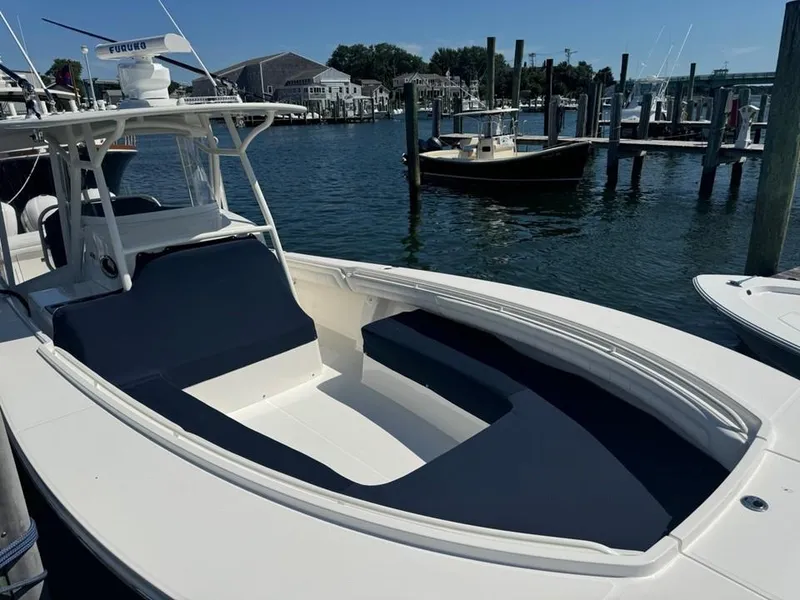 Slide: The Image of 2019 Regulator 34SS boat docked in a marina, featuring sleek design and spacious seating. - 35