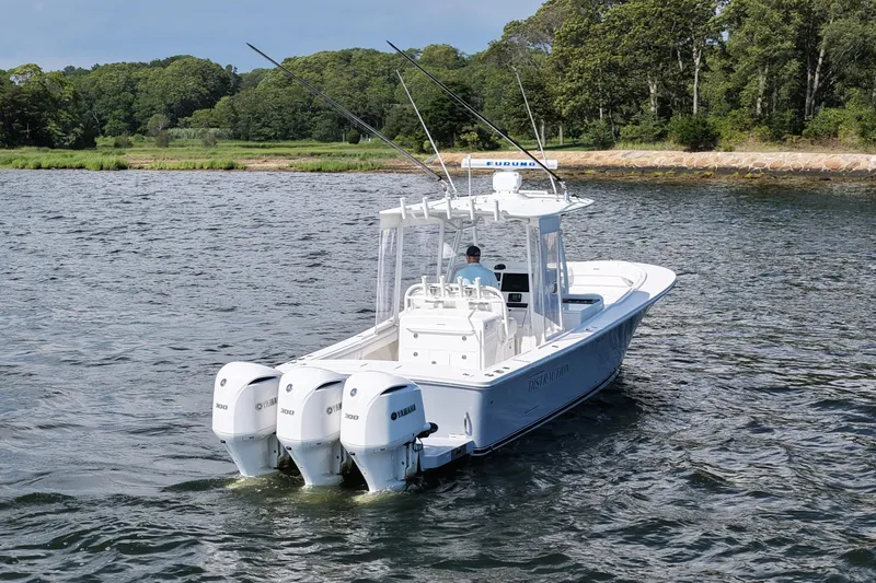 Slide: The Image of 2019 Regulator 34SS boat with triple Yamaha engines on a scenic waterway. - 5
