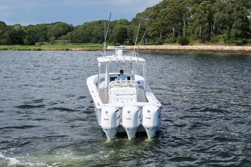 Slide: The Image of 2019 Regulator 34SS boat with triple engines on a scenic waterway. - 6