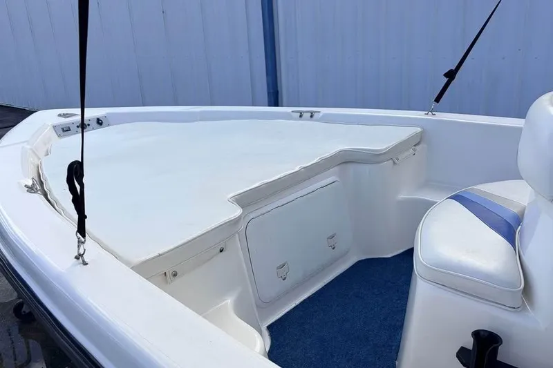 Slide: The Image of 2003 Sea Chaser 1900 CC boat interior with white seating and storage compartments. - 3