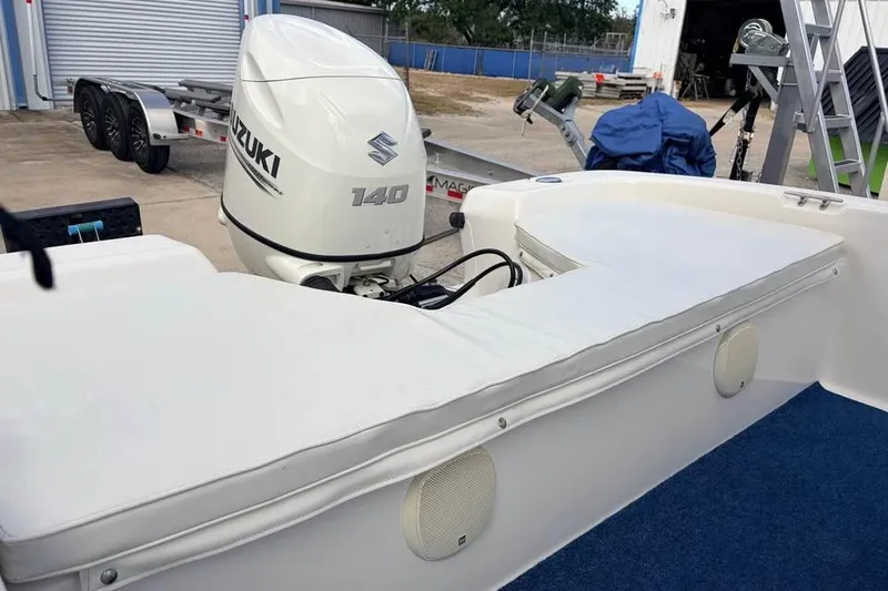 Slide: The Image of 2003 Sea Chaser 1900 CC boat with Suzuki 140 outboard motor in a storage area. - 9