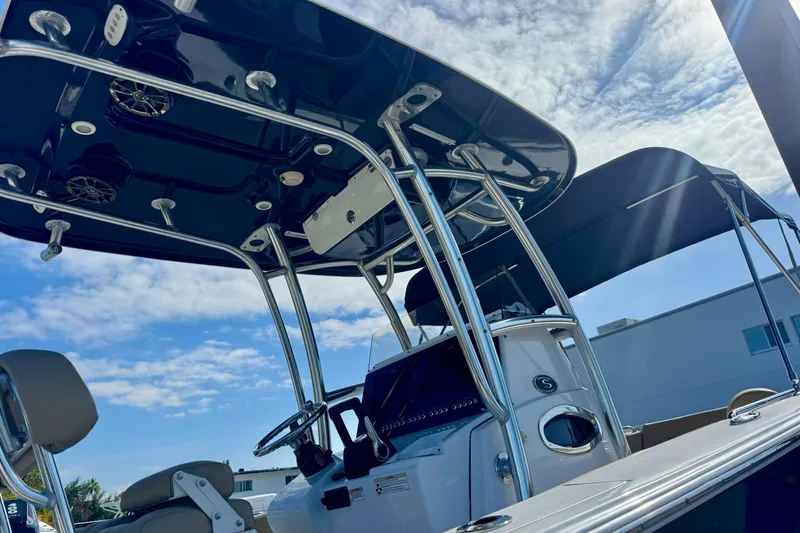 Slide: The Image of 2017 Sportsman Heritage 251 Center Console boat with sleek design under a clear sky. - 11