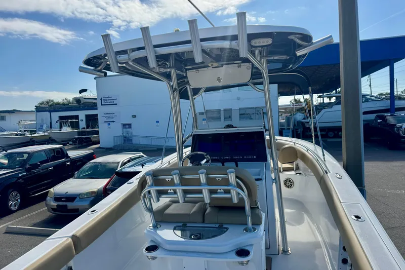 Slide: The Image of 2017 Sportsman Heritage 251 Center Console boat at a dealership, showcasing helm and seating. - 13